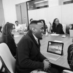 group of people sitting in conference table laughing