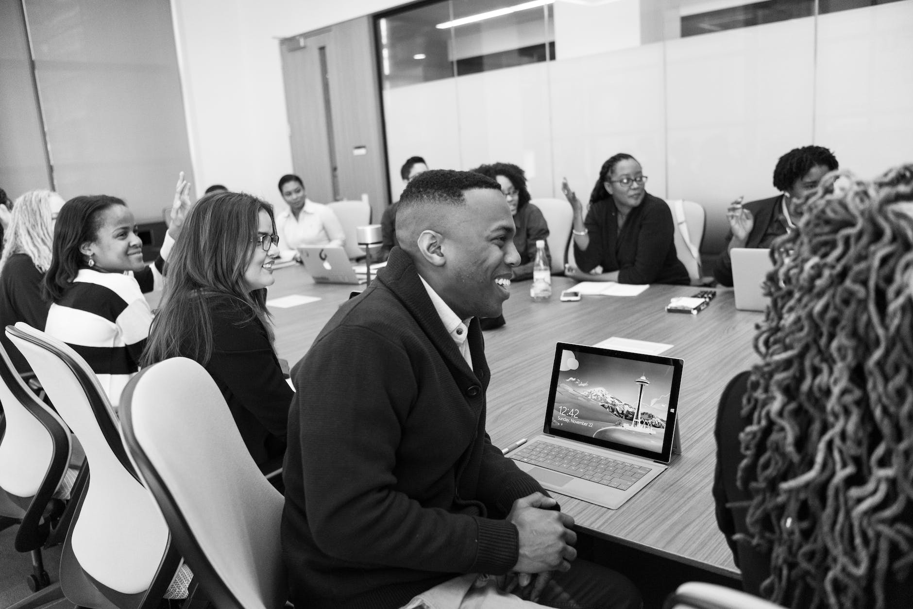 group of people sitting in conference table laughing