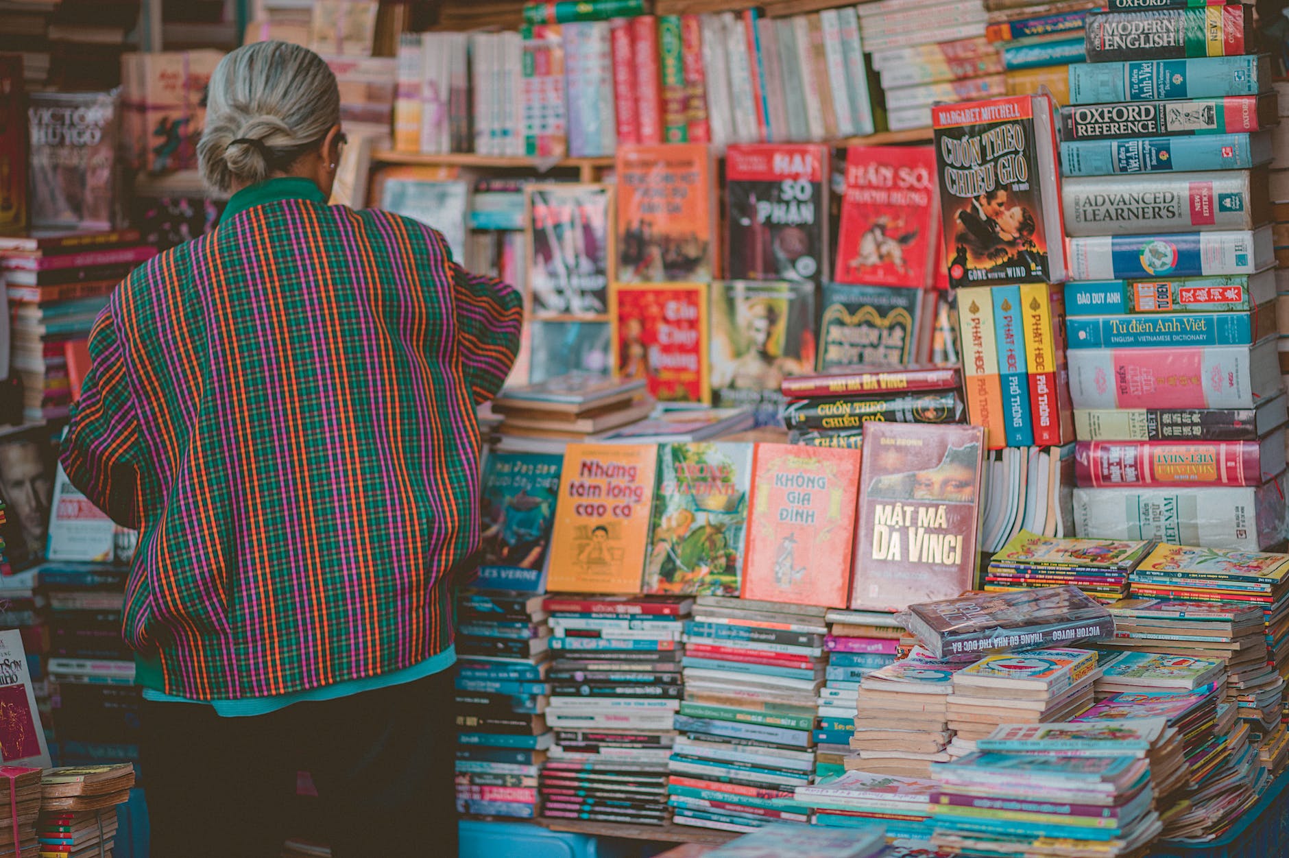 woman standing beside book store