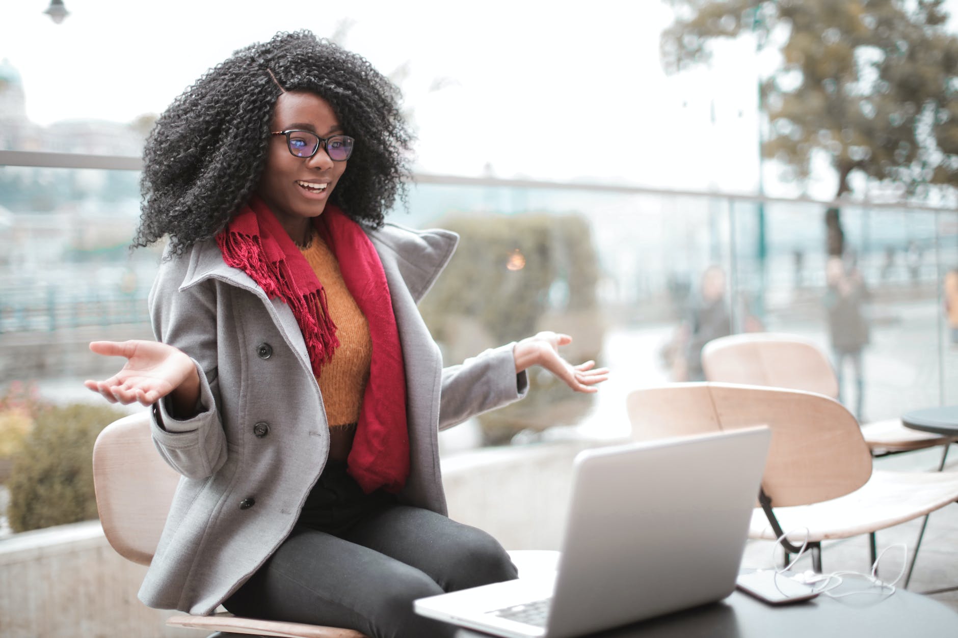 cheerful surprised woman sitting with laptop